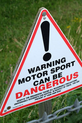 Motor sport is dangerous warning sign.