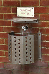 Wall mounted drinking water fountain for public use.