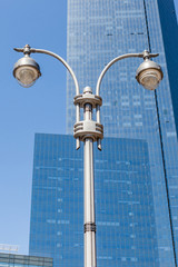Fototapeta na wymiar The streetlights pole with office building background.