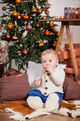 Cute little boy laughing near the Christmas tree
