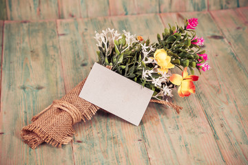 Bouquet of flowers with blank paper tag