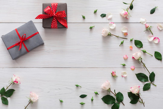 Valentine day background, gift boxes and flowers on white wood