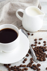 Black coffee in a white cup and coffee