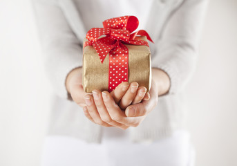 Woman hands holding gift box