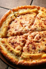 cheese pizza on a wooden board