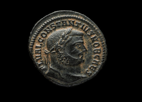 Ancient roman copper coin of emperor Constantius isolated on black