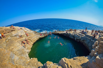Tourists bathing in the Giola. Giola is a natural pool in Thassos island, Greece