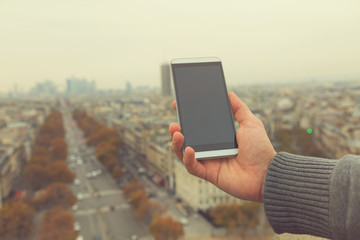 Guy using smartphone in the European city.