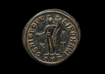 Ancient roman copper coin with warrior image isolated on black