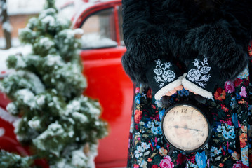 gifts, clock and a red retro car in snowy winter day