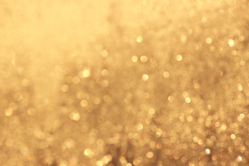 Abstract gold glitter background. Twinkled texture. Bokeh lights