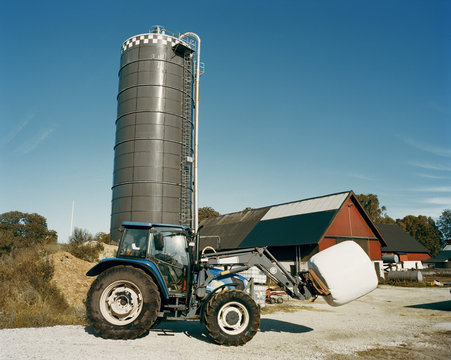 tractor in front of a silo