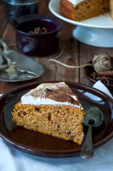 Spicy pumpkin pie with whipped merengue frosting sprinkled with cocoa powder