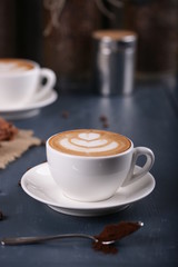 Two cups of coffee on a blue background