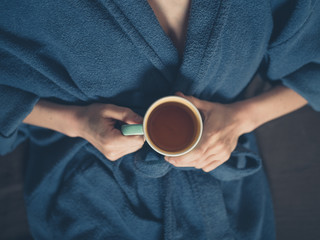 Young woman drinking tea in bed