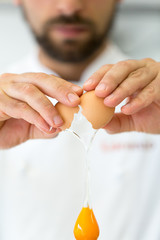 Chef cracking egg