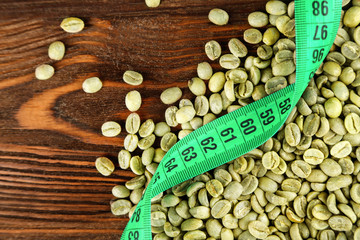 Coffee grains and measure tape on table