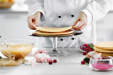 Cooking concept. Professional confectioner making delicious cake, closeup