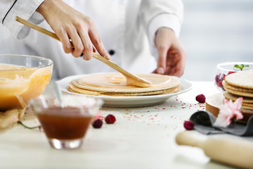 Cooking concept. Professional confectioner making delicious cake, closeup
