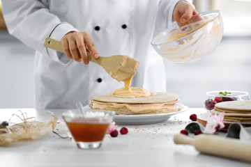 Cooking concept. Professional confectioner making delicious cake, closeup