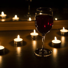 candles and a glass of wine home evening