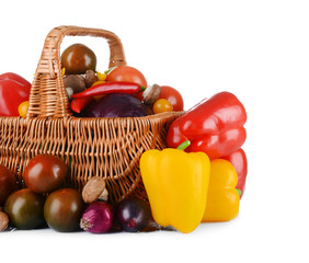 Group of fresh vegetables in basket on white background