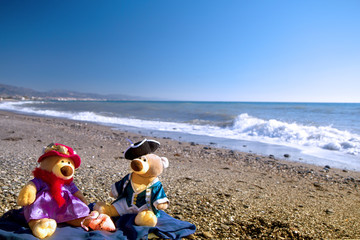 Teddy bears' love date on the seashore at Saint Valentine's day. Sea background. Copy space for text.