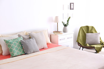 Interior of modern bedroom with cozy double bed