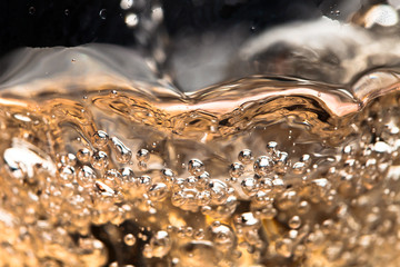white wine in glass on black background