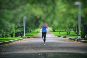 woman jogging in the green park 