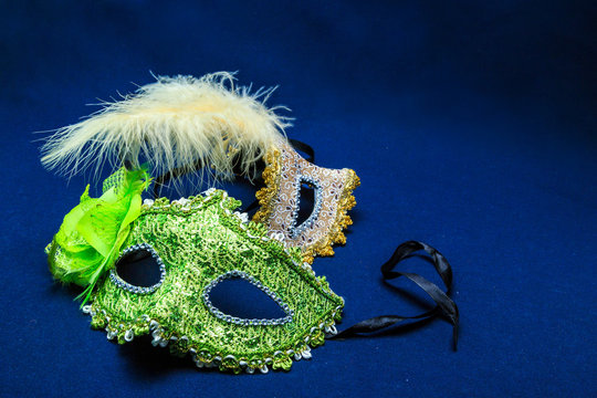 Theatrical masks with ornaments and a feather