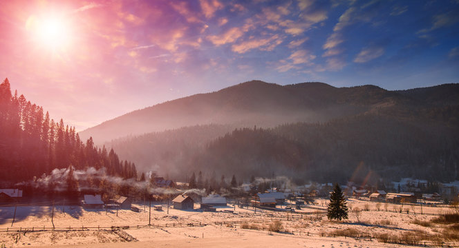 Fototapeta Wonderful winter landscape. Frosty sunny morning over the mountain valley. fog over the hills, under the influence of sunlight. Christmas holiday concept. 