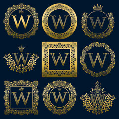 Vintage monograms set of W letter. Golden heraldic logos in wreaths, round and square frames.