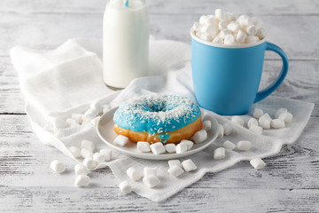 Mlue donut and cup o white table