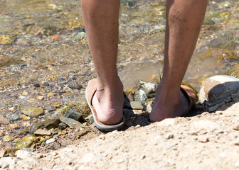 human foot in the river shore