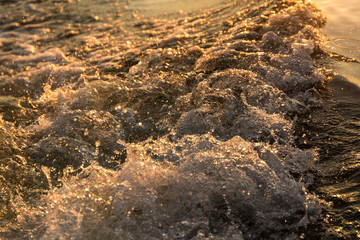 Waves and spray, in sunlight at sunset. Waves in ocean. used as background