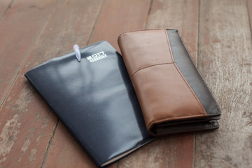 diary year, pen and men wallet on the wood floor