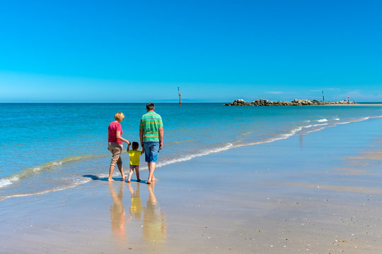Grandfather and grandmother with grandson holding hands - Powered by Adobe