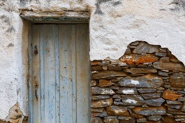 Old wall with a door and visible stonework.