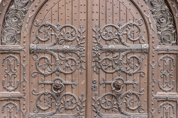 Closeup of old arched wooden door of a churcc