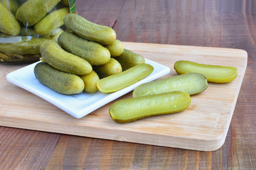 Pickled cucumbers on on wooden board