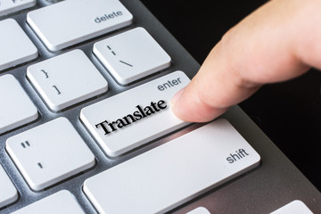 Finger on computer keyboard keys with translate word