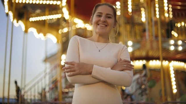 Portrait of smiling young woman in amusement park waiting for date