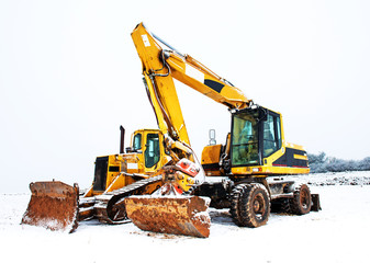 power shovel and bulldozer in snow