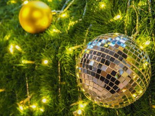 Mirror balls for Christmas and new year day decorate on green grass.