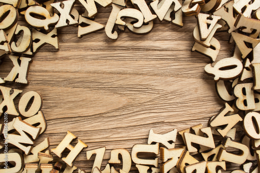 Poster frame made of letters of the alphabet made of wood with empty space for text