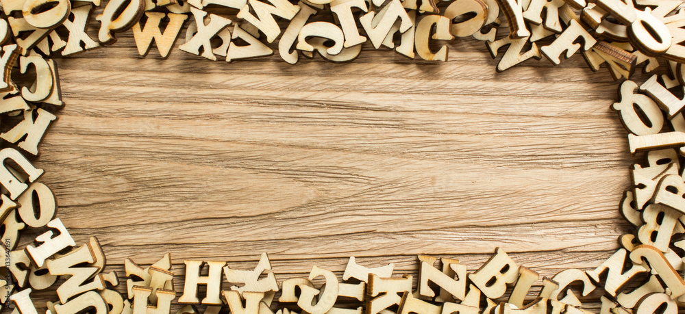 Fototapete Frame made of letters of the alphabet made of wood with empty space for text
