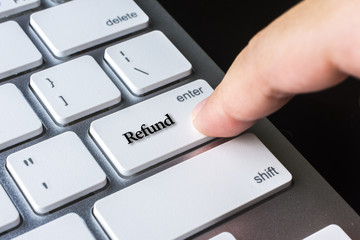 Finger on computer keyboard keys with Refund word