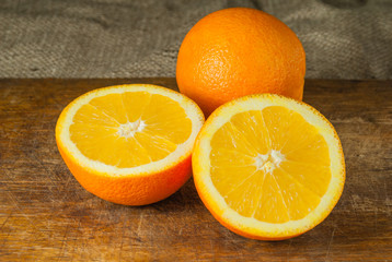 Oranges Fruits and Orange Slice on Wooden Table and Retro Fabric