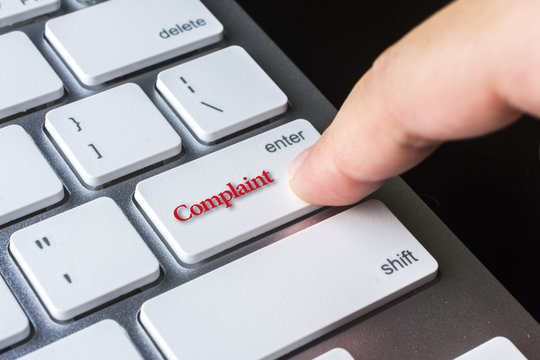 Finger on computer keyboard keys with Complaint word